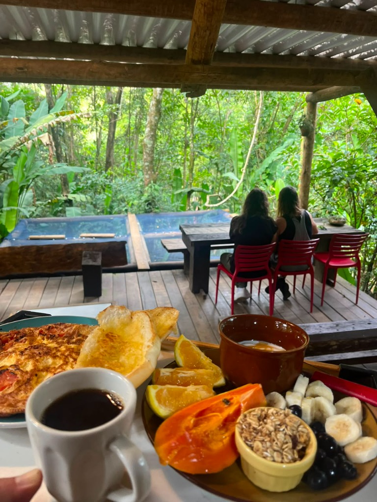 Café da manhã colonial com frutas frescas e vista da floresta no Café da Mata